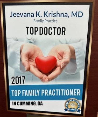 Poster for Dr. Jeevana K. Krishna, MD, recognized as a 2017 Top Doctor and Top Family Practitioner in Cumming, GA, showing hands holding a red heart.